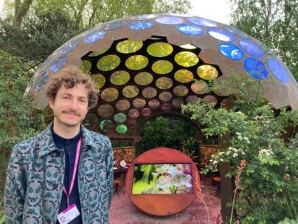 Garden designer Tom Massey in front of his show garden at the RHS Chelsea Flower Show in 2023. 