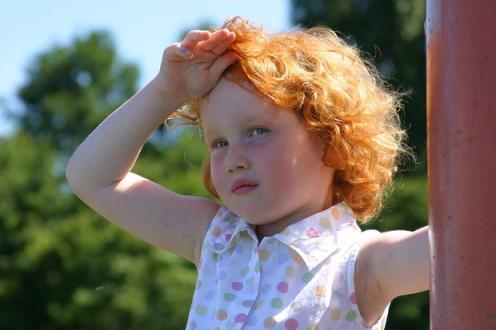 Little girl outside looking hot and flushed