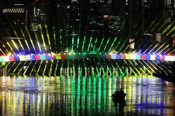 Lights illuminate the "Floesserbruecke" bridge in front of the skyline during a light show rehearsal for UEFA Euro 2024 in Frankfurt, Germany.