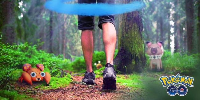 A person walking through a forest with the Pokemon Go Incense mist around them